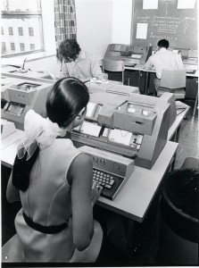 A woman in the computer centre "batching" punch card instructions to DAISY.