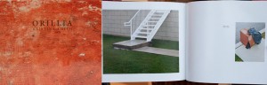 Hardcover book, abstract orange background with the title Orillia and Double page spread, urban scene of a sidewalk, lawn and metal staircase on the left, cardboard box and garbage bags on the right