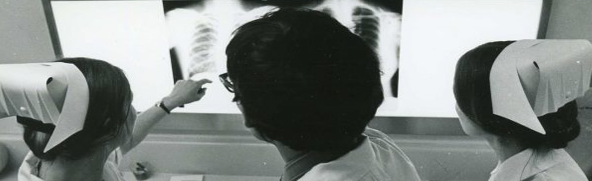 Image of three nurses looking an at x-ray