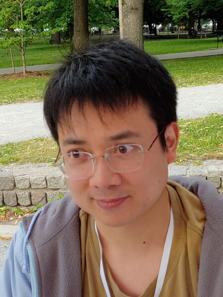 headshot of Dan K. Woo with park setting in the background